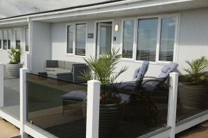 a deck with chairs and a couch on a house at 406 Sea View Road in Bridlington