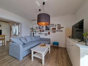 ein Wohnzimmer mit einem blauen Sofa und einem Tisch in der Unterkunft Top view in Crikvenica