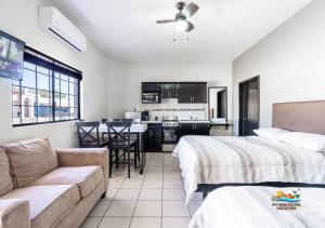 a hotel room with two beds and a couch at San Felipe rental - One block to San Felipe Malecon in San Felipe