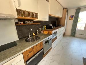 a kitchen with a sink and a counter top at Charmant studio pour 3 personnes in Vallauris