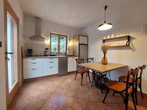 a kitchen with a table and chairs in a room at Olive Garden House in Šibenik