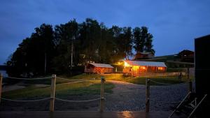 a house with a light on it at night at Wioska Wakacyjna Glamila in Sterławki Wielkie