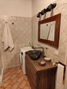 a bathroom with a sink and a washing machine at Dolci Soggiorni in Loreto