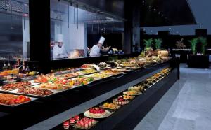 a buffet table filled with lots of different types of food at Pullman Dubai Creek City Centre Residences in Dubai