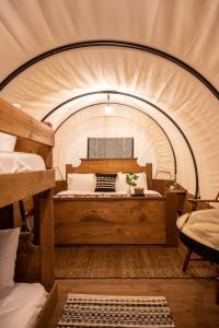 a bedroom with a large bed in a tent at North Haven Campground in Bonners Ferry