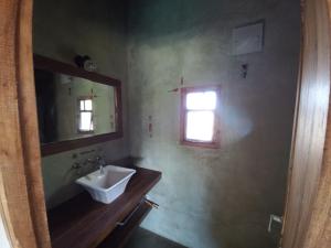 a bathroom with a sink and a mirror and a window at Casas Piedra del Sol in Costa del Este +12 photos