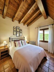 een slaapkamer met een groot bed en een raam bij El Xalet de la Padrille in Enveitg
