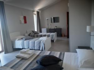 A bed or beds in a room at Un passo dal mare - Guest House