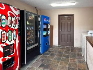 アトランタにあるMotel 6 Atlanta GA Atlanta Airport Eastのコカコーラマシン2台とドア1台が備わる部屋