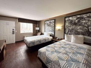 a hotel room with two beds and a window at Motel 6 Atlanta GA Atlanta Airport East in Atlanta