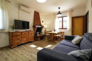 a living room with a couch and a tv and a table at Lijana in Bratulići (Haus für 4 Personen) in Barban