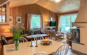 a kitchen and living room with a table and chairs at Stunning Home In Skodje With Wifi And 4 Bedrooms in Skodje