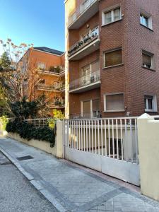 a white fence in front of a brick building at BEST FLAT NEAR REAL MADRID STADIUM in Madrid