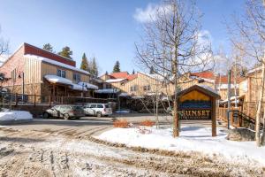 a street in a town with a sign in the snow at Ultimate Group Getaway, Spacious Multi-Level Retreat Close to Downtown SSET13 in Breckenridge