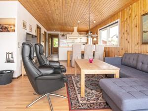 a living room with a couch and a table at 4 person holiday home in Harbo re in Harboør