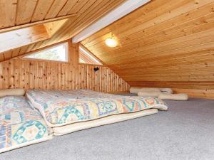 a bedroom with two beds in a wooden cabin at 6 person holiday home in Fur-By Traum in Fur