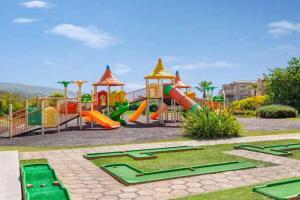 a park with a playground with a slide and a slideintend at CLC Wyndham Kuşadası Golf resort in Soke