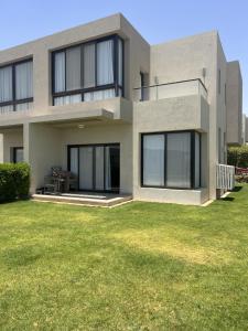 a house with a green lawn in front of it at Azha ain sokhna Luxury vacation villa - families only in Ain Sokhna