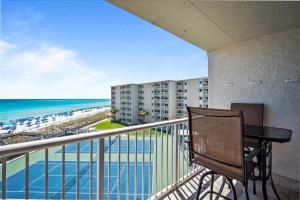 a balcony with a table and a view of the beach at Holiday Surf and Racquet Unit 520 in Destin
