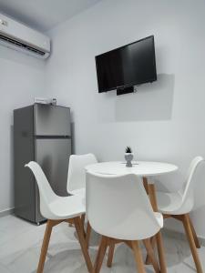 a white dining room with a white table and chairs at Alexander Luxury Apartments & Studios in Metamorfosi +7 photos