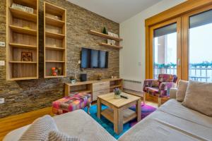 a living room with a couch and a tv at S35, vila Elsa 1 in Zlatibor