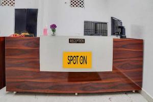 a reception desk in an office with wooden floors at Hotel O Rudraksh Residency in Bhilai