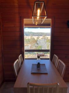 a dining room with a table and a large window at Lappi Farm in Berridale