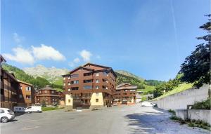 un edificio en una calle con montañas en el fondo en 1 Bedroom Lovely Apartment In Allos en La Foux