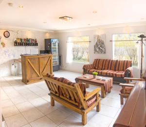 a living room with couches and a table at Tranqueras Lodge in El Chalten