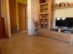 a living room with a flat screen tv on a entertainment center at Casa rural Butaka in Alcalá del Júcar