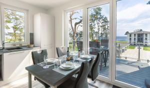 a kitchen and dining room with a table and chairs at Apartment "Sanddorn" - Haffresidenz in Garz-Usedom