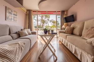 ein Wohnzimmer mit Sofa und Tisch in der Unterkunft Acogedor Bungalow Park Florimar in Tarragona