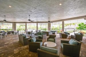 a lobby with couches and tables and chairs at Bonita Springs Vacation Rental with Pool Access! in Bonita Springs