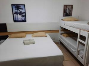 a room with two bunk beds in it at Hotel Natal in Santos