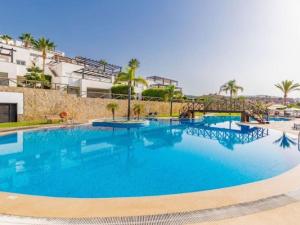 a large swimming pool with blue water at Dúplex de Lujo Marbella Golf in Marbella