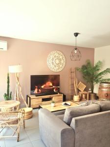 a living room with a couch and a fireplace at AppartCosy Emplacement Idéal avec Terrasse & Parking Privé in Nîmes