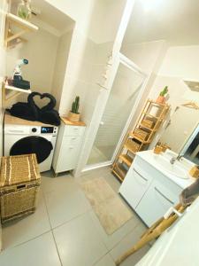 a kitchen with white cabinets and a sink and a counter at AppartCosy Emplacement Idéal avec Terrasse & Parking Privé in Nîmes