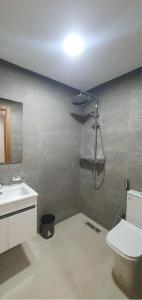 a bathroom with a shower and a toilet and a sink at Maison Lapierre d'agadir in Agadir