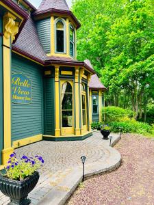 a large house with a patio in front of it at Belle View Manor Inn in Harbour Grace