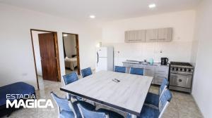 a kitchen with a table and chairs and a refrigerator at Cabañas en Valle Grande in Valle Grande