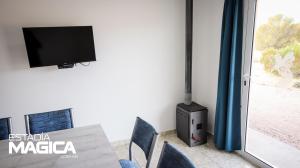 a dining room with a tv and a table and chairs at Cabañas en Valle Grande in Valle Grande