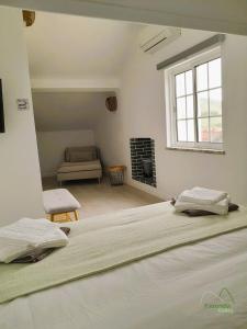 a bedroom with a large bed and a living room at Fazenda Valley in Santa Cruz das Flores