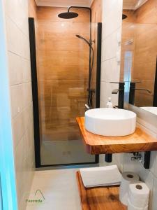 a bathroom with a sink and a shower at Fazenda Valley in Santa Cruz das Flores