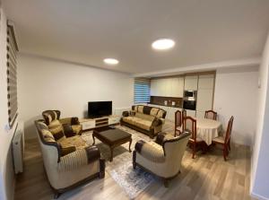 a living room with couches and a dining room at Tregu fatoni prizren apartment 3bedroom in Prizren