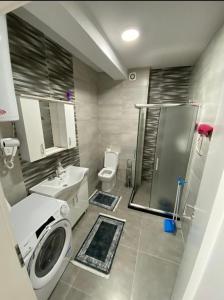 a bathroom with a sink and a washing machine at Tregu fatoni prizren apartment 3bedroom in Prizren
