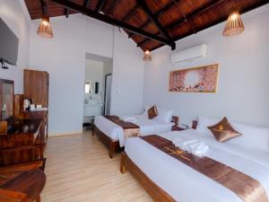 Postel nebo postele na pokoji v ubytování The Poplar Resort Phú Quốc