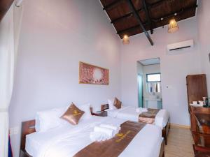 Postel nebo postele na pokoji v ubytování The Poplar Resort Phú Quốc
