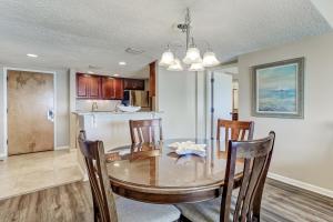 a dining room and kitchen with a table and chairs at Atlantic Ocean View Condo with Private Balcony and Access to Beachside Pool condo in Fernandina Beach