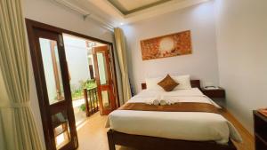 Postel nebo postele na pokoji v ubytování The Poplar Resort Phú Quốc
