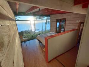 een slaapkamer met een bed en uitzicht op de oceaan bij Cabaña Rustica en lagunillas con vista al mar in Navidad